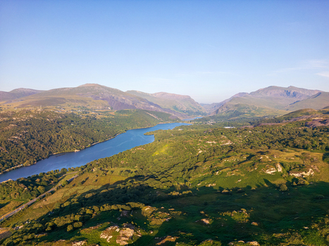 Aerial view of Llyn Padarn surrounded by lush green mountains and rolling hills in the Snowdonia region of Cwm y glo Wales United Kingdom. Aerial view of Llyn Padarn surrounded by lush green mountains and rolling hills in the Snowdonia region of Cwm y glo Wales United Kingdom.