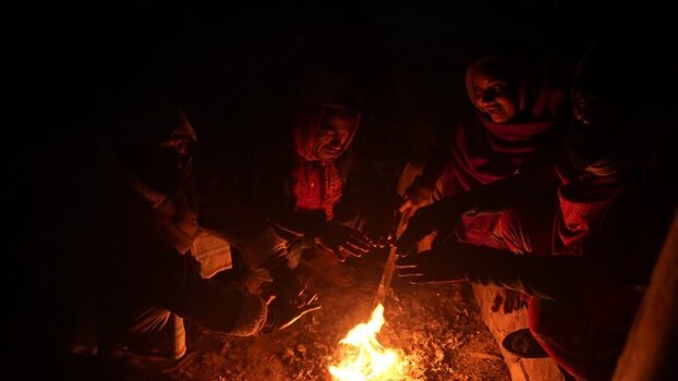 View of people warming their hands by a fire at night Bangladesh. View of people warming their hands by a fire at night Bangladesh.