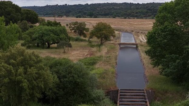Aerial view of an irrigation canal through rural fields Portugal. Aerial view of an irrigation canal through rural fields Portugal.