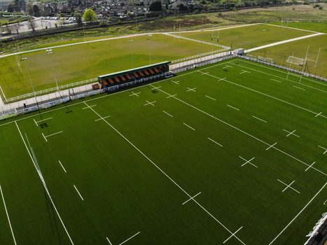 Stafford United Kingdom 23 April 2020 Aerial view of Stafford Rugby Union Football Club featuring green rugby pitches with white markings a small grandstand and surrounding residential area. Stafford United Kingdom 23 April 2020 Aerial view of Stafford Rugby Union Football Club featuring green rugby pitches with white markings a small grandstand and surrounding residential area.