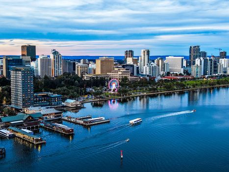 Aerial view of the Perth skyline featuring the Elizabeth Quay ferris wheel modern skyscrapers and boats on the Swan River in Perth Western Australia Australia.