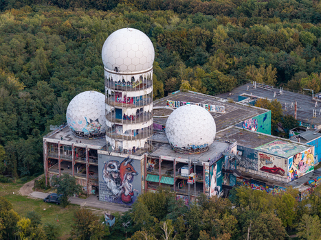 Aerial view of the abandoned Teufelsberg NSA Station with its iconic geodesic domes covered in street art surrounded by the dense Grunewald forest in Berlin Berlin Germany.