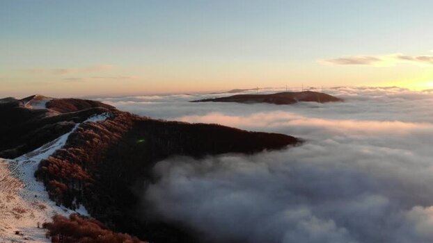 Aerial view of Balkan Mountains above clouds at sunset Bulgaria.