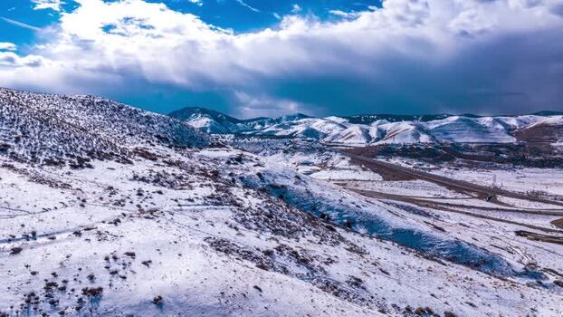 Aerial view of snowy mountains and highway near Denver United States.
