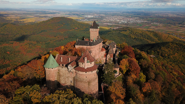 Aerial view of the historic Chateau du Haut Koenigsbourg surrounded by vibrant autumn foliage in the Vosges mountains in Orschwiller Grand Est France.