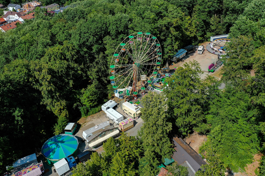 Forchheim Germany 19 July 2025 Aerial view of the Annafest fairground with its iconic Ferris wheel surrounded by dense green forest and festival trailers. Forchheim Germany 19 July 2025 Aerial view of the Annafest fairground with its iconic Ferris wheel surrounded by dense green forest and festival trailers.