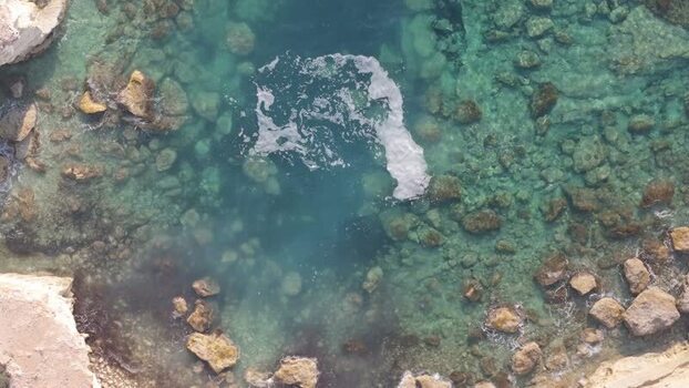 Aerial view of turquoise sea water and rocky coastline Cyprus.