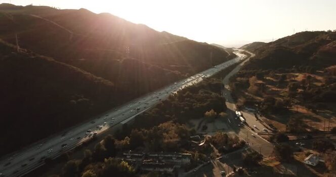 Aerial view of highway traffic through hills United States. Aerial view of highway traffic through hills United States.