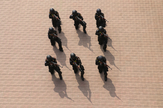 Dhaka Bangladesh 06 January 2017 View of Rapid Action Battalion RAB officers in black uniforms kneeling in formation and aiming rifles during a drill at the RAB Headquarters. Dhaka Bangladesh 06 January 2017 View of Rapid Action Battalion RAB officers in black uniforms kneeling in formation and aiming rifles during a drill at the RAB Headquarters.