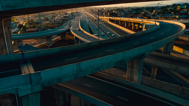 Aerial view of the Pokuase Interchange featuring multi level concrete flyovers flowing traffic and surrounding urban landscape in Ga North Municipal Greater Accra Region Ghana. Aerial view of the Pokuase Interchange featuring multi level concrete flyovers flowing traffic and surrounding urban landscape in Ga North Municipal Greater Accra Region Ghana.