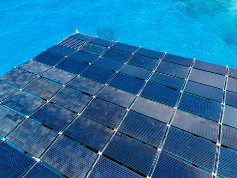 Aerial view of the SolarSea floating solar power plant by Swimsol with blue solar panels on turquoise ocean water in Dharavandhoo Baa Atoll Maldives. Aerial view of the SolarSea floating solar power plant by Swimsol with blue solar panels on turquoise ocean water in Dharavandhoo Baa Atoll Maldives.