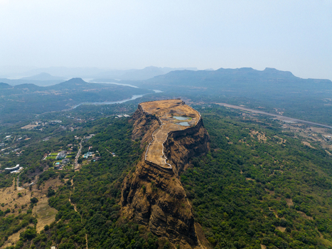 Aerial view of Korigad Fort with its historic stone walls and water reservoirs surrounded by lush green forests and rolling hills in Peth Shahapur Maharashtra India. Aerial view of Korigad Fort with its historic stone walls and water reservoirs surrounded by lush green forests and rolling hills in Peth Shahapur Maharashtra India.