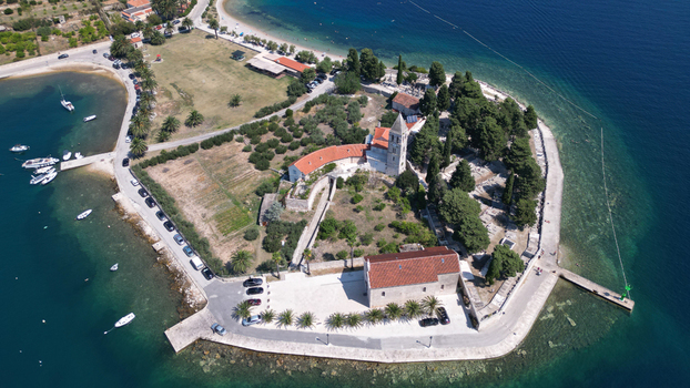 Aerial view of the historic St. Jerome s Church and Franciscan Monastery on the Prirovo peninsula surrounded by turquoise waters in Vis Split Dalmatia County Croatia. Aerial view of the historic St. Jerome s Church and Franciscan Monastery on the Prirovo peninsula surrounded by turquoise waters in Vis Split Dalmatia County Croatia.