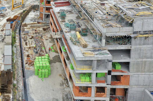 Aerial view of a large construction site with workers concrete structures and green building materials in Avcilar Istanbul Turkiye. Aerial view of a large construction site with workers concrete structures and green building materials in Avcilar Istanbul Turkiye.
