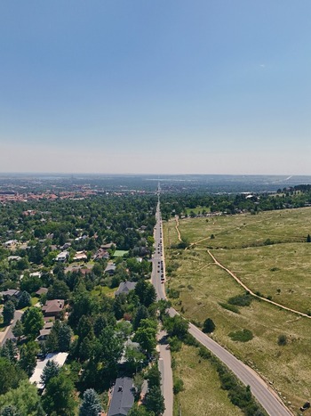 Aerial view of Chautauqua Park with its expansive grassy fields and trails adjacent to the residential neighborhoods and tree lined streets of Boulder Colorado United States. Aerial view of Chautauqua Park with its expansive grassy fields and trails adjacent to the residential neighborhoods and tree lined streets of Boulder Colorado United States.
