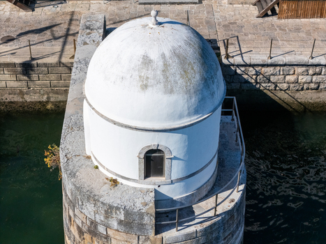 Aerial view of the historic Cascais Tide Gauge featuring its distinctive white dome and stone masonry situated along the coastline in Cascais Lisboa Portugal. Aerial view of the historic Cascais Tide Gauge featuring its distinctive white dome and stone masonry situated along the coastline in Cascais Lisboa Portugal.