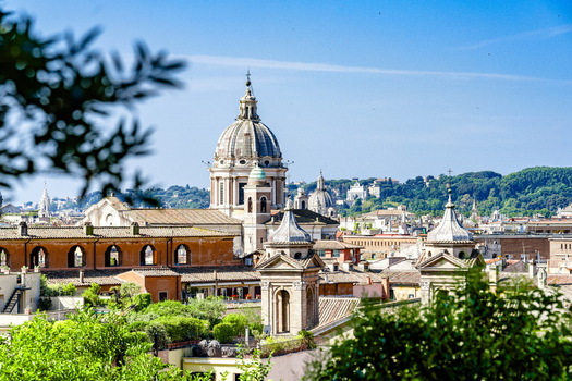 View of the historic skyline with majestic church domes and terracotta rooftops under a clear blue sky in Rome Lazio Italy. View of the historic skyline with majestic church domes and terracotta rooftops under a clear blue sky in Rome Lazio Italy.