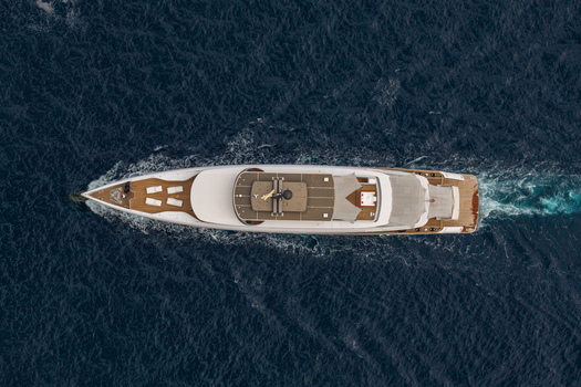 Aerial view of a luxury yacht cruising on the deep blue sea near Ile Sainte Marguerite with a visible wake Cannes Provence Alpes Cote d Azur France. Aerial view of a luxury yacht cruising on the deep blue sea near Ile Sainte Marguerite with a visible wake Cannes Provence Alpes Cote d Azur France.