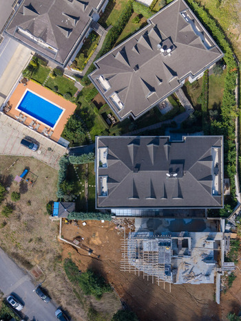 Aerial view of modern residential houses with swimming pools and a construction site in a suburban neighborhood in Istanbul Istanbul Turkiye. Aerial view of modern residential houses with swimming pools and a construction site in a suburban neighborhood in Istanbul Istanbul Turkiye.