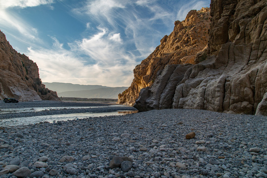 View of rugged cliffs embrace a winding riverbed under a serene sky creating a mesmerizing dance of light and shadow Pakistan View of rugged cliffs embrace a winding riverbed under a serene sky creating a mesmerizing dance of light and shadow Pakistan