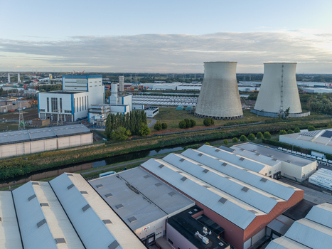 Vilvoorde Belgium 29 August 2026 Aerial view of the former power plant with iconic cooling towers industrial buildings warehouses and a canal in an urban landscape.