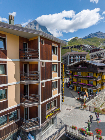 Aerial view of the Sporting Hotel in Breuil Cervinia featuring wooden balconies alpine architecture and mountain peaks Breuil Cervinia Aosta Valley Italy. Aerial view of the Sporting Hotel in Breuil Cervinia featuring wooden balconies alpine architecture and mountain peaks Breuil Cervinia Aosta Valley Italy.