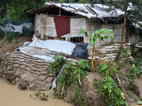 Cox s Bazar Bangladesh 19 July 2026 View of a makeshift shelter constructed from bamboo plastic tarps and sandbags on a muddy embankment in a refugee camp. Cox s Bazar Bangladesh 19 July 2026 View of a makeshift shelter constructed from bamboo plastic tarps and sandbags on a muddy embankment in a refugee camp.