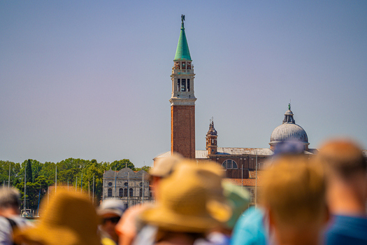 Venice Italy 29 March 2026 View of the iconic bell tower of San Giorgio Maggiore rising majestically against the azure sky framed by the blurred silhouettes of onlookers. Venice Italy 29 March 2026 View of the iconic bell tower of San Giorgio Maggiore rising majestically against the azure sky framed by the blurred silhouettes of onlookers.