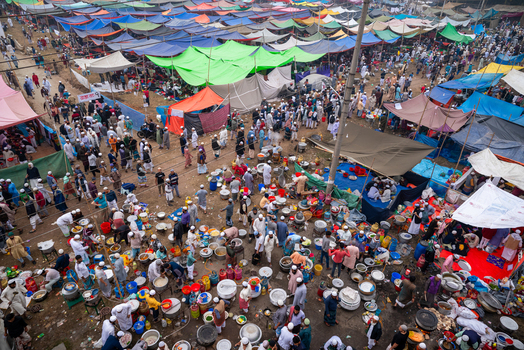 Tongi Bangladesh 31 January 2025 Aerial view of Tongi Ijtema Maidan with a large crowd of people preparing meals in large pots under colorful tarps during the Bishwa Ijtema.