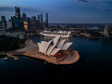 Aerial view of the iconic Sydney Opera House and the Harbour Bridge reflecting the last light of dusk contrasted against the dark waters Sydney New South Wales Australia. Aerial view of the iconic Sydney Opera House and the Harbour Bridge reflecting the last light of dusk contrasted against the dark waters Sydney New South Wales Australia.