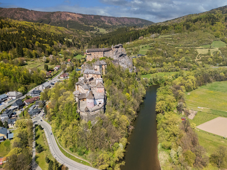 Aerial view of Orava Castle on a high rock cliff overlooking the river and lush green hills in Dolny Kubin Zilinsky kraj Slovakia. Aerial view of Orava Castle on a high rock cliff overlooking the river and lush green hills in Dolny Kubin Zilinsky kraj Slovakia.
