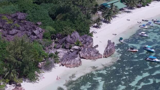 Aerial view of Curieuse Island beach and granite boulders Seychelles.