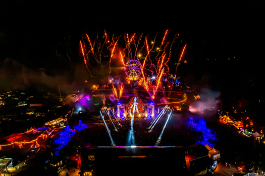 Herzogenaurach Germany 27 July 2025 Aerial view of the Open Beatz Festival with fireworks exploding over the stage a glowing Ferris wheel and vibrant lights at night. Herzogenaurach Germany 27 July 2025 Aerial view of the Open Beatz Festival with fireworks exploding over the stage a glowing Ferris wheel and vibrant lights at night.