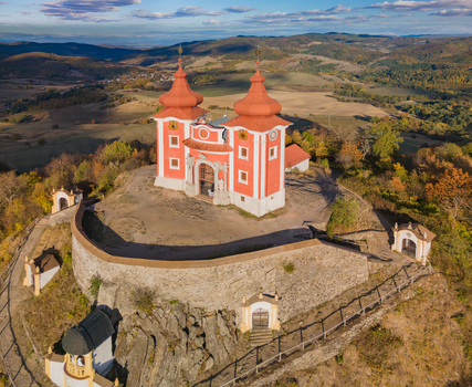 Aerial view of the historic Stiavnicka Kalvaria pilgrimage site with its red roofed church and stone walls set atop a hill in Banska Stiavnica Banskobystricky kraj Slovakia. Aerial view of the historic Stiavnicka Kalvaria pilgrimage site with its red roofed church and stone walls set atop a hill in Banska Stiavnica Banskobystricky kraj Slovakia.
