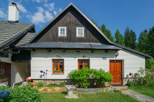 View of quaint architecture with dark wood contrasting against the white walls greenery and colourful tiles Donovaly Banskobystricky kraj Slovakia. View of quaint architecture with dark wood contrasting against the white walls greenery and colourful tiles Donovaly Banskobystricky kraj Slovakia.