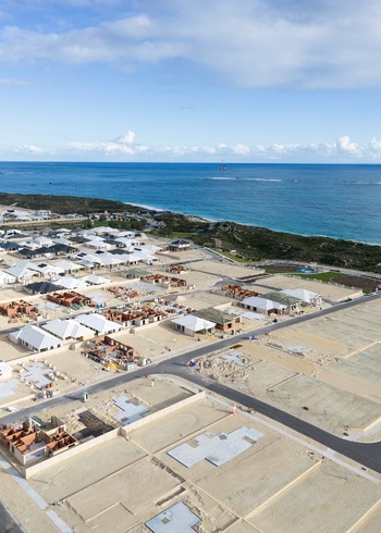 Aerial view of a residential development under construction with new houses building foundations and paved roads near the coastline in Perth Western Australia Australia. Aerial view of a residential development under construction with new houses building foundations and paved roads near the coastline in Perth Western Australia Australia.