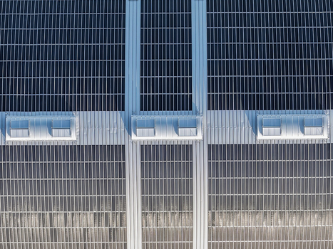 Aerial view of solar panels installed on a large industrial roof with integrated skylights in Uckermark Brandenburg Germany. Aerial view of solar panels installed on a large industrial roof with integrated skylights in Uckermark Brandenburg Germany.
