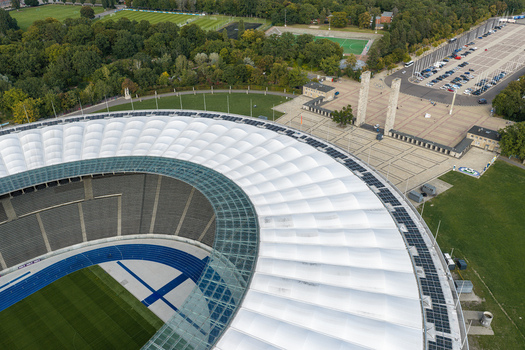 Berlin Berlin Germany 26 September 2026 Aerial view of Olympiastadion Berlin with its distinctive white roof blue running track and surrounding green parkland on a clear day.