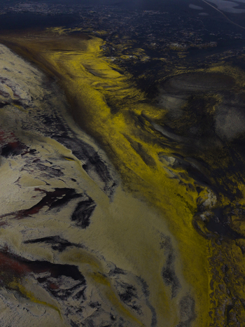 Aerial view of winding rivers cutting through a surreal landscape of vibrant yellow and dark volcanic sands creating a textured tapestry Landmannalaugar Iceland. Aerial view of winding rivers cutting through a surreal landscape of vibrant yellow and dark volcanic sands creating a textured tapestry Landmannalaugar Iceland.