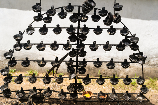 View of traditional oil lamps on a metal stand at the Japanese Peace Pagoda Rumassala in Unawatuna Southern Province Sri Lanka. View of traditional oil lamps on a metal stand at the Japanese Peace Pagoda Rumassala in Unawatuna Southern Province Sri Lanka.