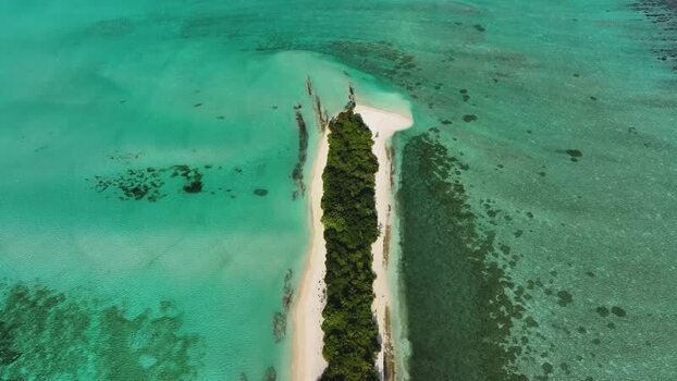 Aerial view of a tropical island and turquoise water Maldives.