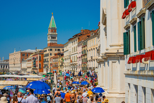 Venice Italy 29 March 2026 View of the bustling Riva degli Schiavoni crowded with tourists the Campanile di San Marco piercing the azure sky. Venice Italy 29 March 2026 View of the bustling Riva degli Schiavoni crowded with tourists the Campanile di San Marco piercing the azure sky.