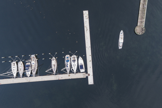 Aerial view of sailboats docked at a pier in the calm waters of Sando in Vallda Hallands lan Sweden.