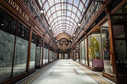Newcastle upon Tyne England United Kingdom 13 July 2026 View of the historic Central Arcade with ornate wooden storefronts glass vaulted ceiling and intricate mosaic floor. Newcastle upon Tyne England United Kingdom 13 July 2026 View of the historic Central Arcade with ornate wooden storefronts glass vaulted ceiling and intricate mosaic floor.