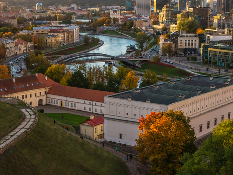 Aerial view of the Neris River curving through the city with the Gediminas Tower and the Old Town buildings basking in the warm sunlight Vilnius Lithuania. Aerial view of the Neris River curving through the city with the Gediminas Tower and the Old Town buildings basking in the warm sunlight Vilnius Lithuania.
