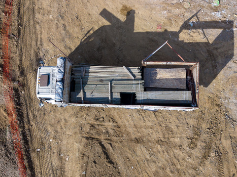 Aerial view of a truck loaded with wooden planks and construction materials on a dirt construction site in Istanbul Istanbul Turkiye.