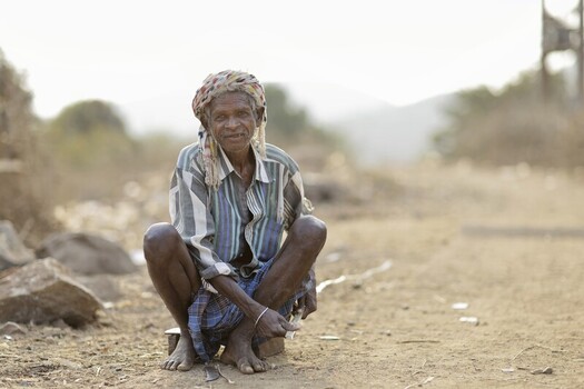 Odisha India 26 March 2026 View of an elderly woman with weathered skin and a vibrant headscarf squats on the sun baked earth a portrait of resilience. Odisha India 26 March 2026 View of an elderly woman with weathered skin and a vibrant headscarf squats on the sun baked earth a portrait of resilience.