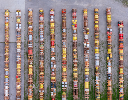 Aerial view of rows of stacked farm tractor parts and tire rims arranged in a storage yard in Ingersoll Ontario Canada. Aerial view of rows of stacked farm tractor parts and tire rims arranged in a storage yard in Ingersoll Ontario Canada.