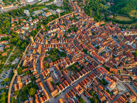 Aerial view of the historic town of Rothenburg ob der Tauber with dense red tiled rooftops medieval fortifications and narrow streets in Rothenburg ob der Tauber Bavaria Germany. Aerial view of the historic town of Rothenburg ob der Tauber with dense red tiled rooftops medieval fortifications and narrow streets in Rothenburg ob der Tauber Bavaria Germany.
