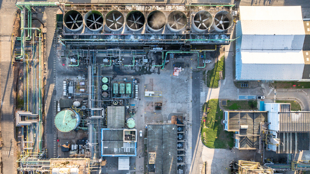 Aerial view of a petrochemical complex featuring large cooling fans industrial piping storage tanks and factory buildings in Santo Andre State of Sao Paulo Brazil.